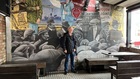 Close to Waring Street, Robert Beatty stands at the mural that includes his great grandfather, a politician and trade unionist Alex Boyd (immediately to the right of Robert with the black banded boater hat)